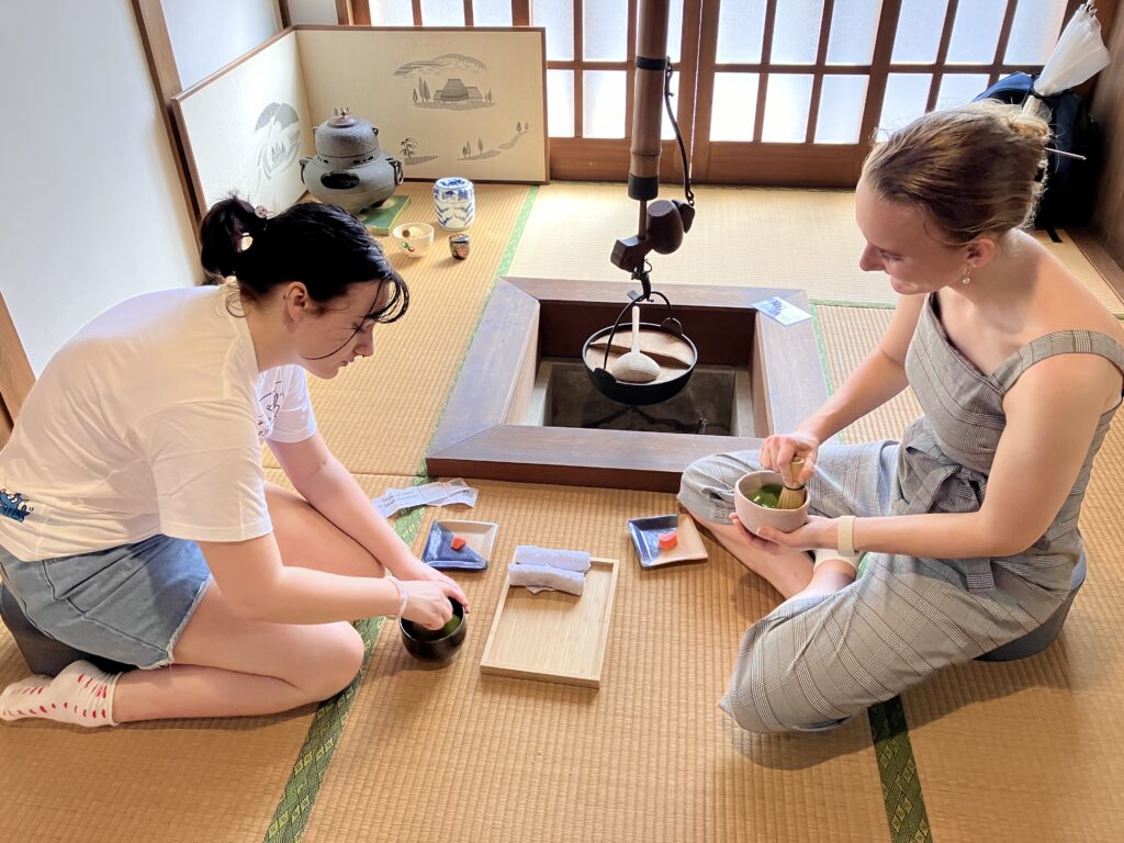 A photo of the participants enjoying making matcha by themselves by the traditional Japanese Irori heath.