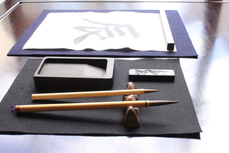 A photo of the calligraphy tools and the character "dragon".