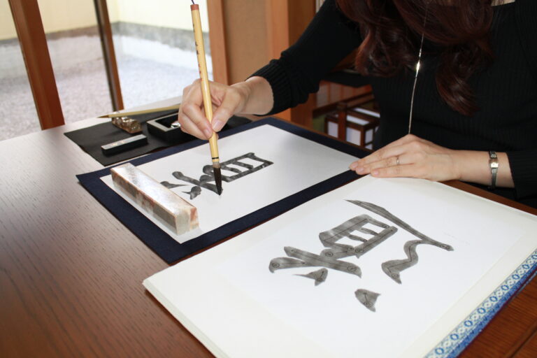 A photo of a guest practicing calligraphy.