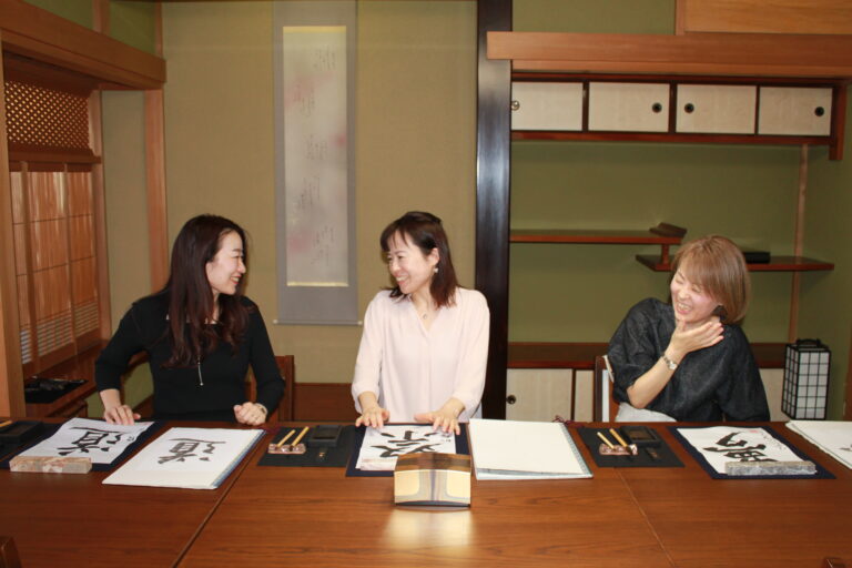 A photo of guests enjoying calligraphy.