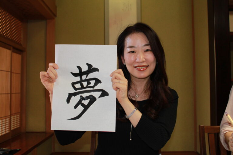 A Photo of a guest with her calligraphy work.