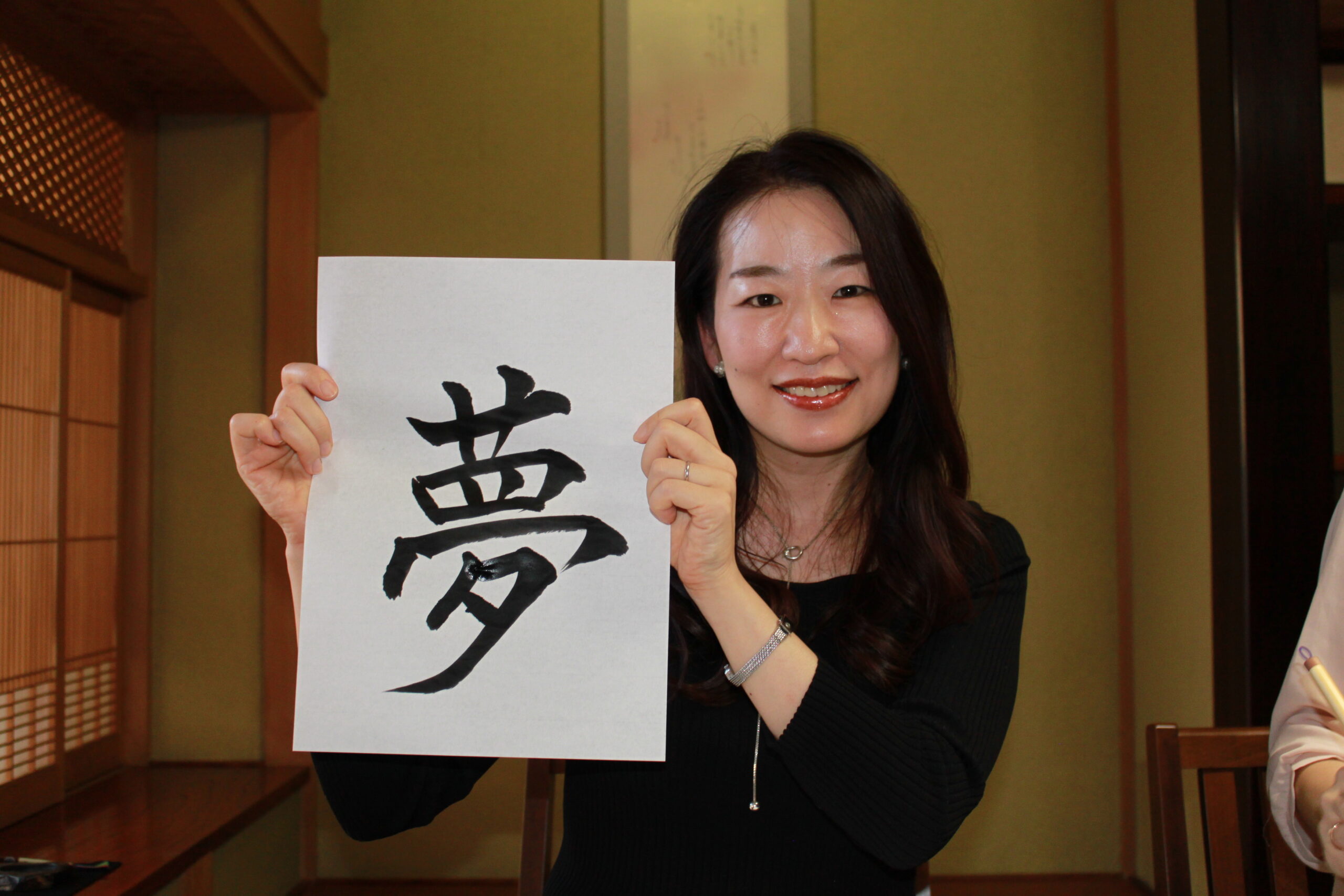 A Photo of a guest with her calligraphy work.