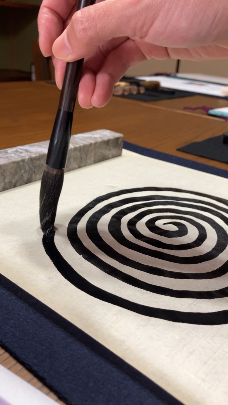 A photo of someone practicing calligraphy by drawing spirals.