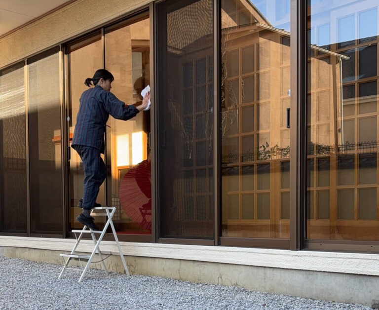 A photo of a staff cleaning up the windows.