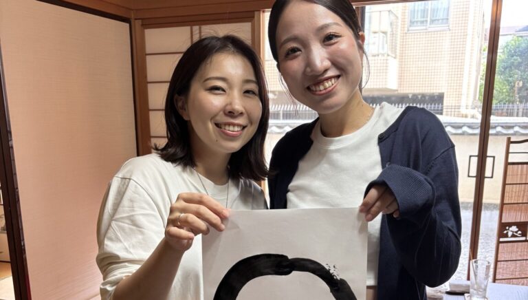 A photo of our guests with their calligraphy work.