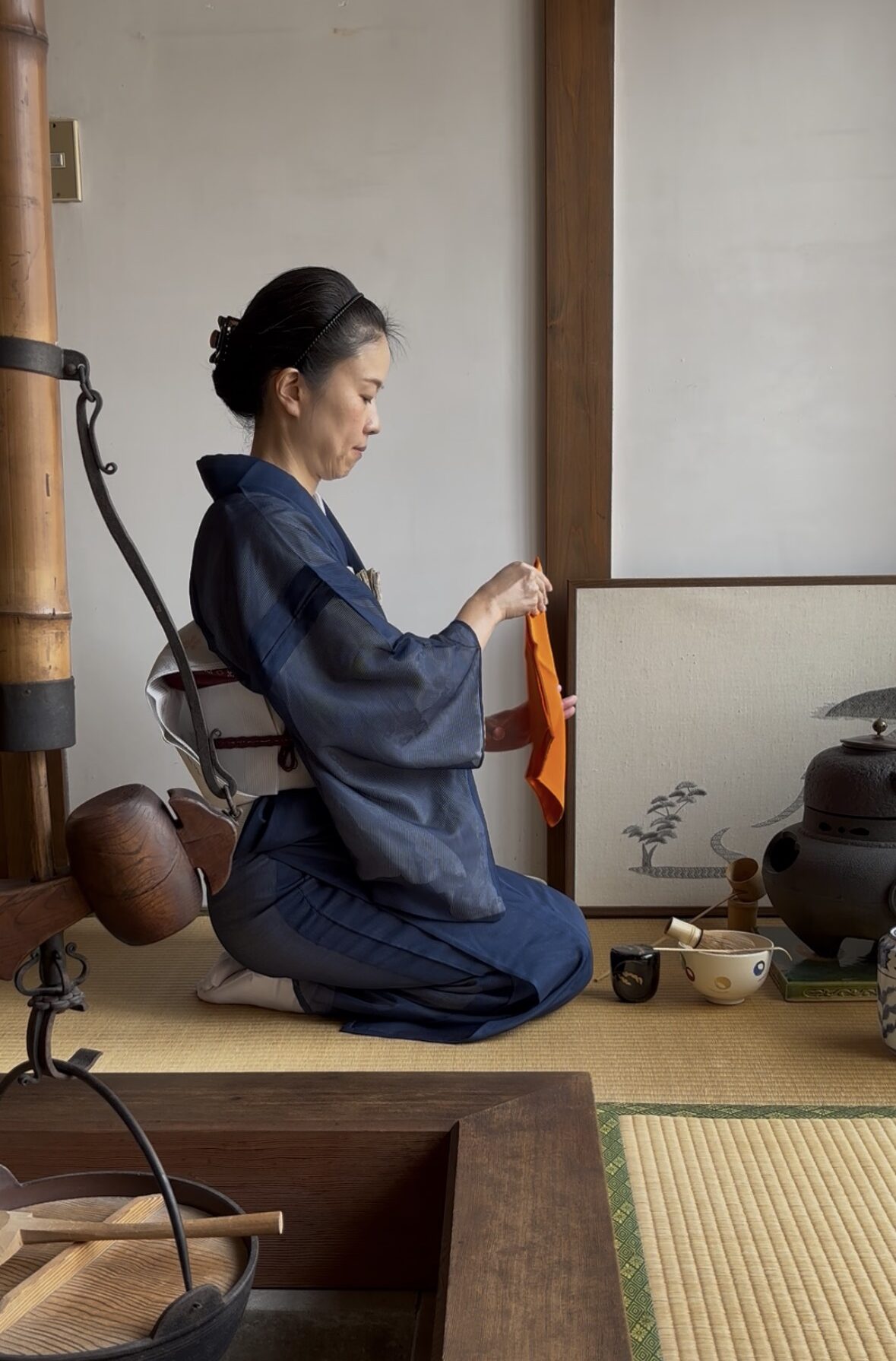 A photo of the manager preparing some matcha in the tea ceremony.