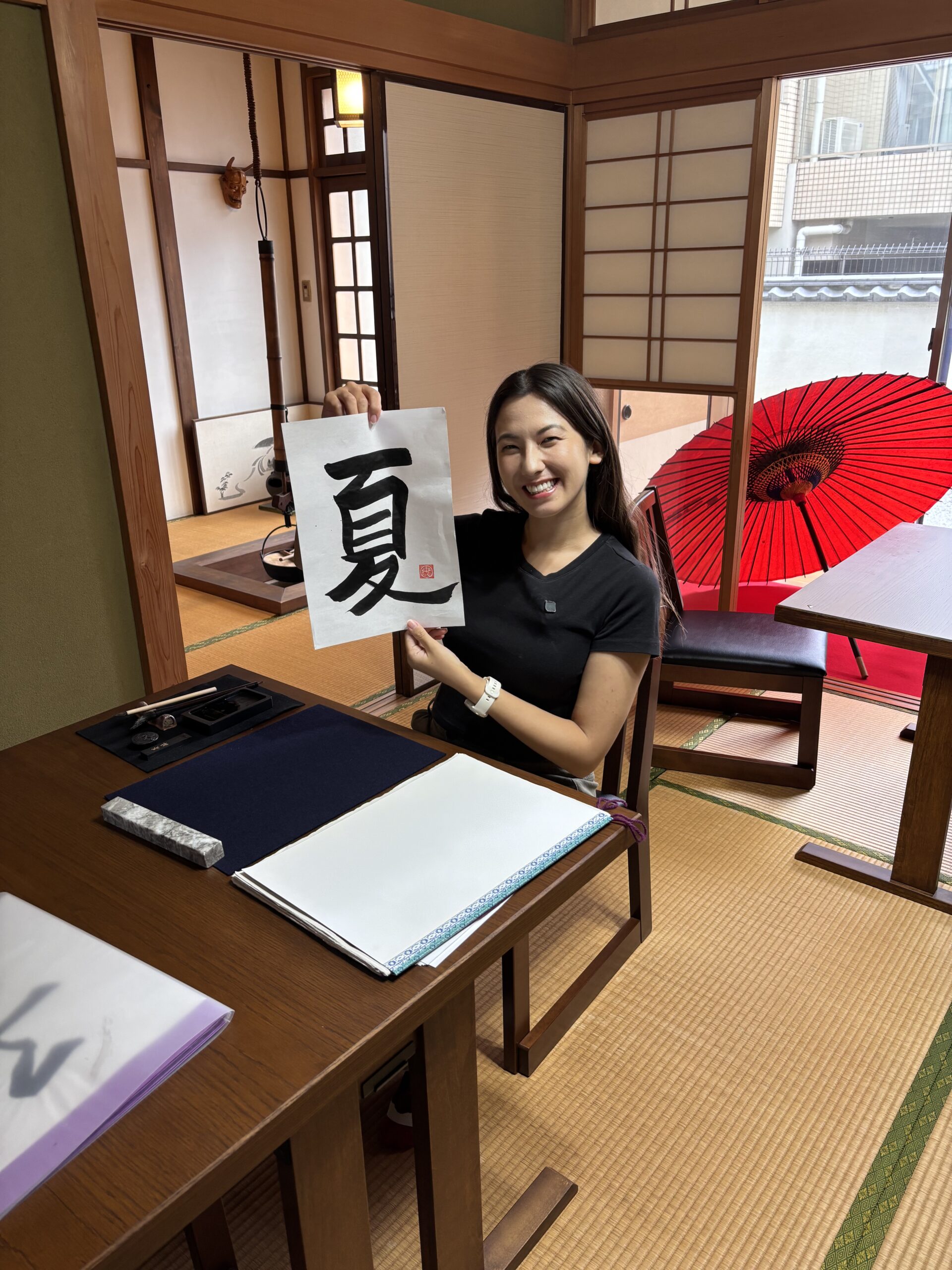 Our guest showing her calligraphy 'summer'.