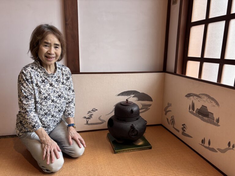 Photo of Eiko-san and her Embroidery work.