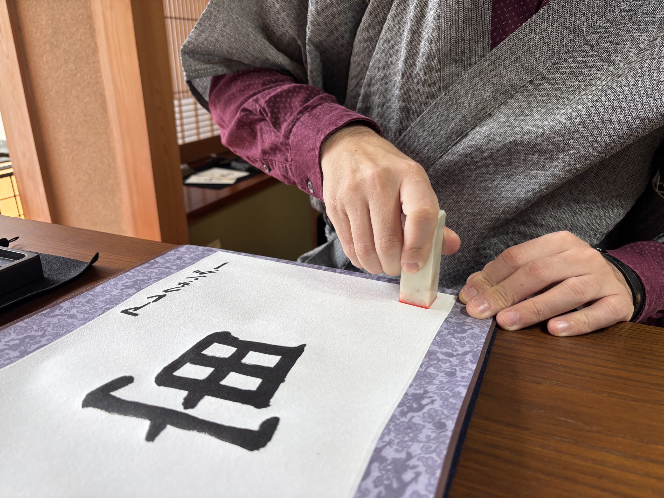 A photo of stamping the seal, hanko.