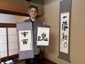 A photo of our guest with his calligraphy pieces.