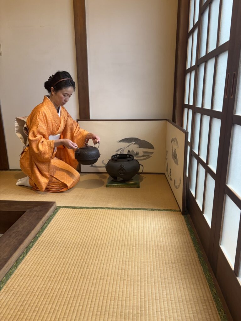 Photo of the manager holding a kama.