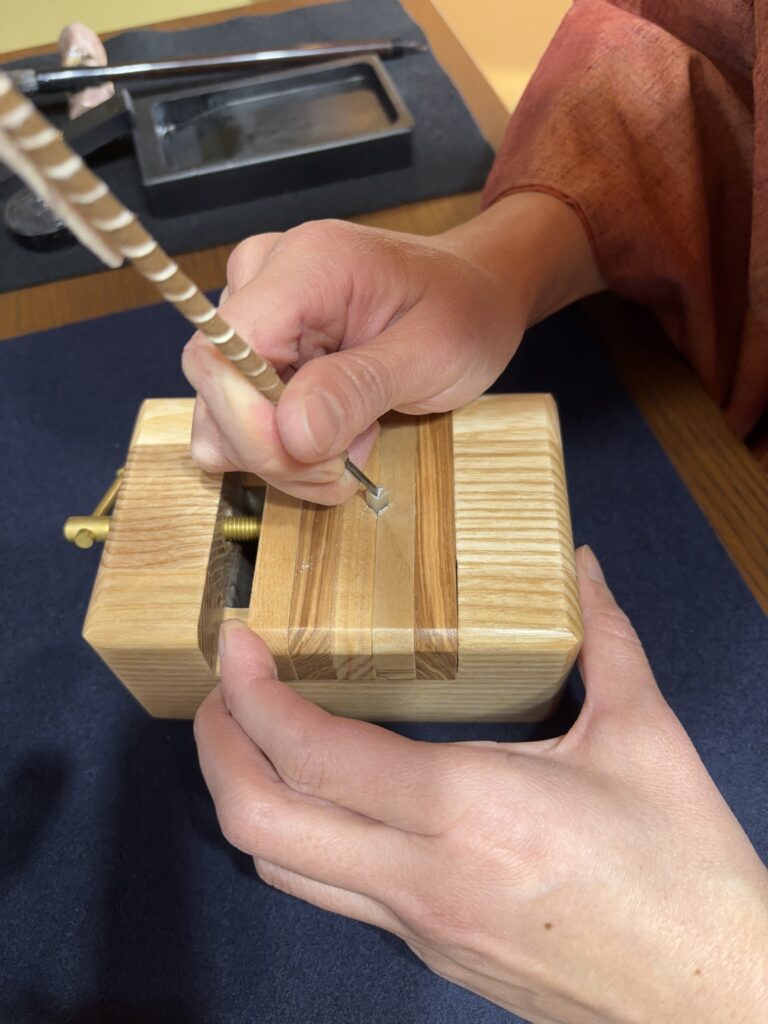 Carving stone with a knife.