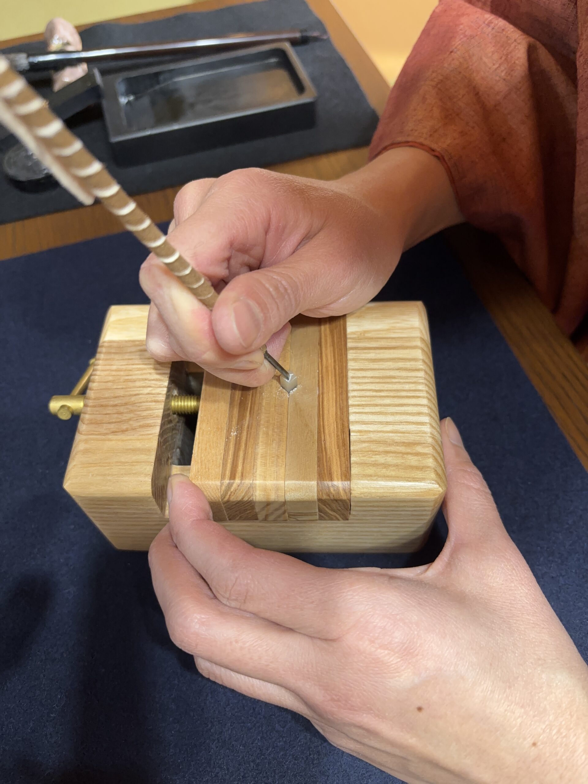 Carving stone with a knife.