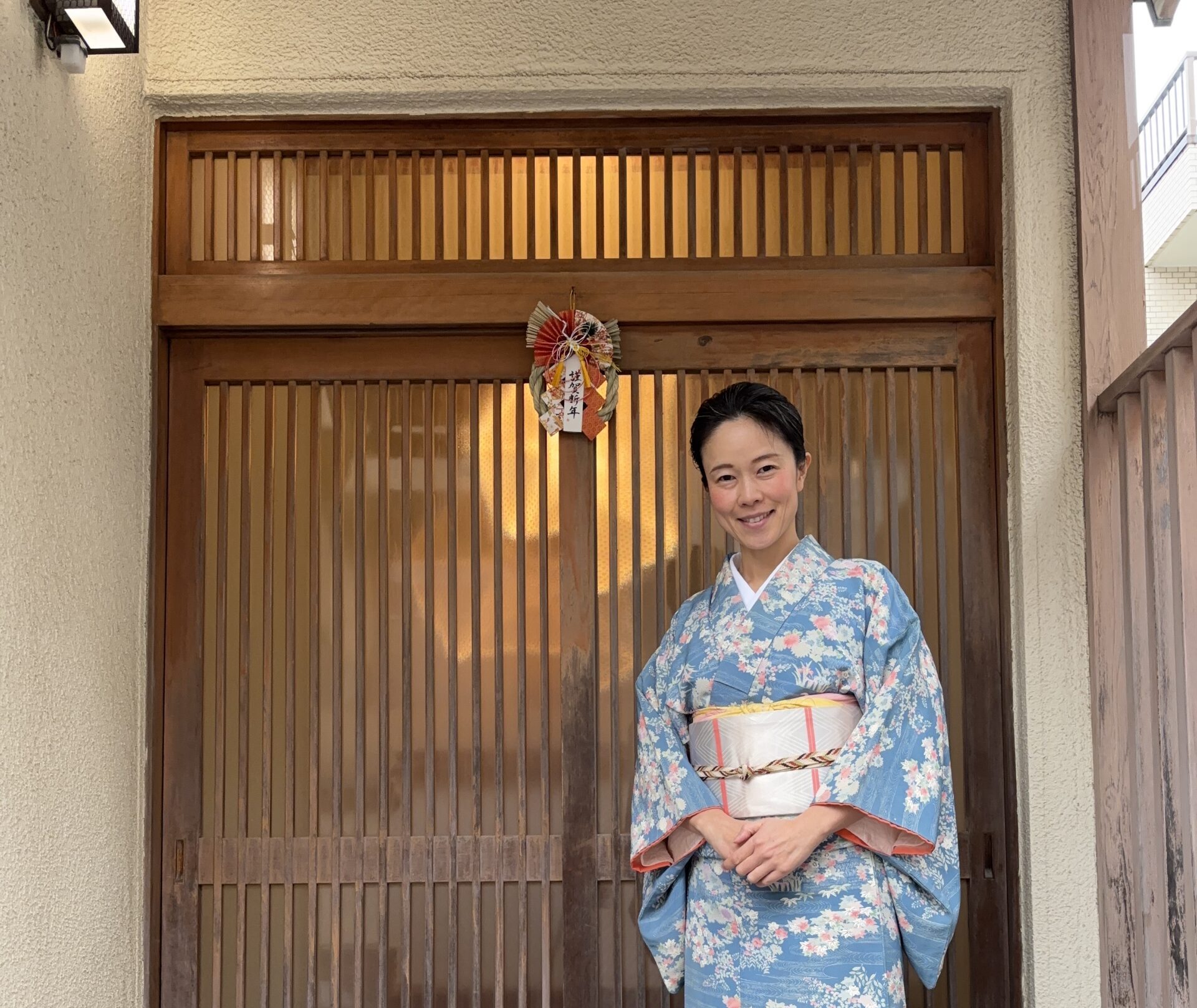 The manager and the Japanese New Year Decoration at the front door.