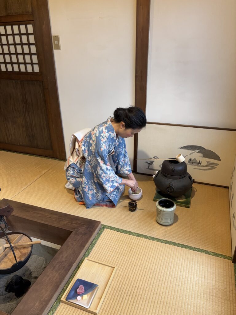 The manager in kimono whisking matcha.