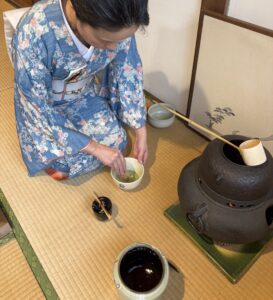 The manager in kimono whisking matcha.