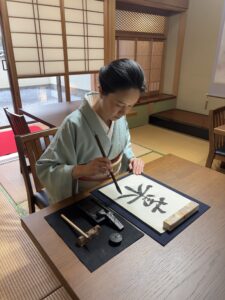 the manager is holding a calligraphy brush