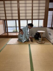 The host is preparing matcha tea.