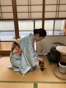 The host is preparing matcha tea.