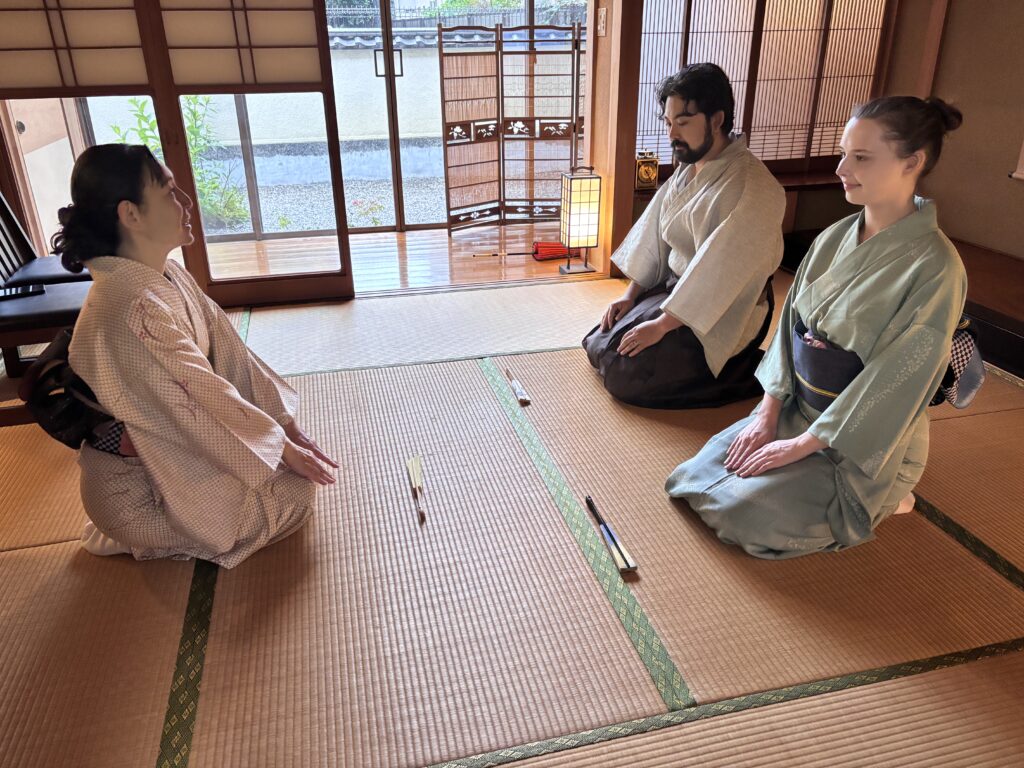 Guests and the instructor sitting on tatami for greeting.